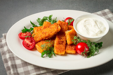 fried fish nuggets, with white sauce, arugula and cherry, no people,