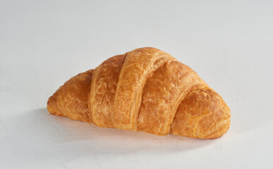 Plain mini croissant on a white surface - Isolated