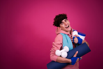 Funny sportsman and retro style. The guy poses on a pink background.