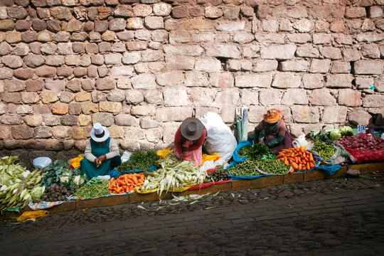 Women selling corn and other organic vegetables in the streets of the city of Cusco in Peru.