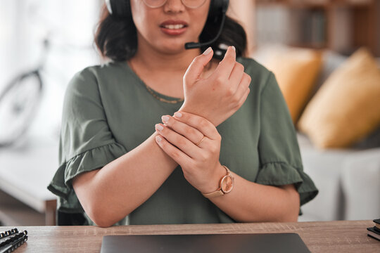 Woman, hands and wrist pain in remote work from injury, typing or overworked by desk at home office. Closeup of female person or call center consultant with sore ache, joint or carpal tunnel syndrome