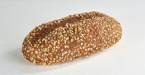 A closeup of a whole grain brown bread on white - isolated