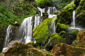 Fototapeta na wymiar Wild Alps, the green waterfall