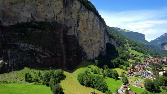 Switzerland Lauterbrunnen valley Staubbach waterfall 4K drone. Aerial Alpine view. Scenic mountain village in Bernese Oberland. Summer travel. Jungfrau region