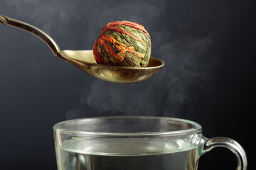 Chinese green tea ball with jasmine and marigold (calendula) flowers.