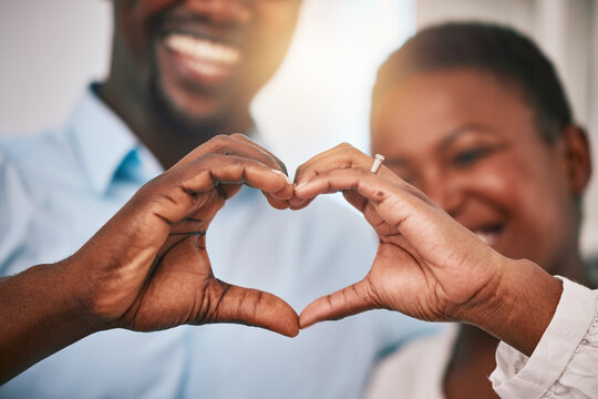 Hands in heart, love and couple with sign by home with gesture for love, support and care. Emoji, happy and closeup of black man and woman with shape for bonding, commitment and healthy marriage