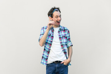 Optimistic glad excited man makes gesture with fore finger upwards, having great idea, smiling,...