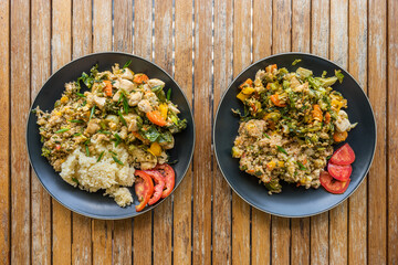 Cooked couscous and quinoa with vegetables and chicken meat served on plate. Balanced healthy nutrition food