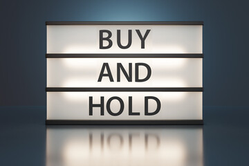 Cinema light box showing the alphabet BUY AND HOLD. Illustration of the concept of long term investing strategy