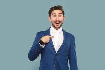 Portrait of excited amazed handsome man with mustache standing pointing at himself with surprised...