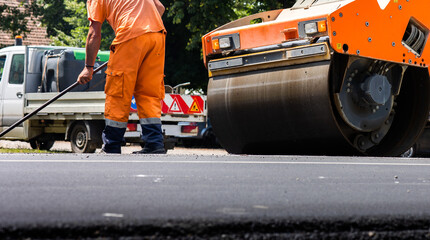 Compactor roller during road construction at asphalting work