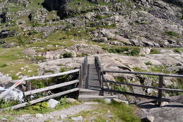 wooden bridge of the path that leads to the cornisello lakes in the trentino dolomites