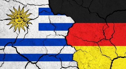 Flags of Uruguay and Germany on cracked surface - politics, relationship concept
