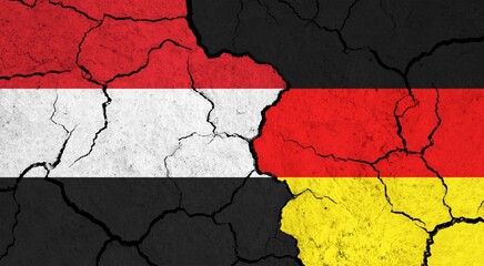 Flags of Yemen and Germany on cracked surface - politics, relationship concept