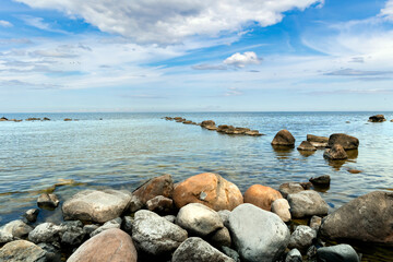 Fototapeta na wymiar Kaltene Beach is a great place for quite beach holidays and beach hiking. Kaltene Beach is covered with glacial stones that stretches up to Roja Town in Latvia