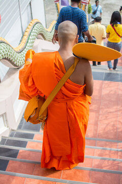 Monk walking down the stair of the church Buddhist ordination ceremony in the temple, Thailand