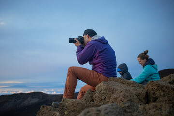 Family taking pictures at Haleakala watching the sunrise over the Pacific, Maui, Hawaii, USA