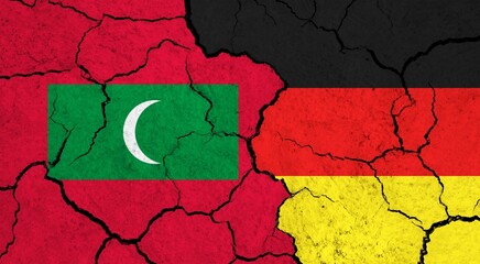 Flags of Maldives and Germany on cracked surface - politics, relationship concept