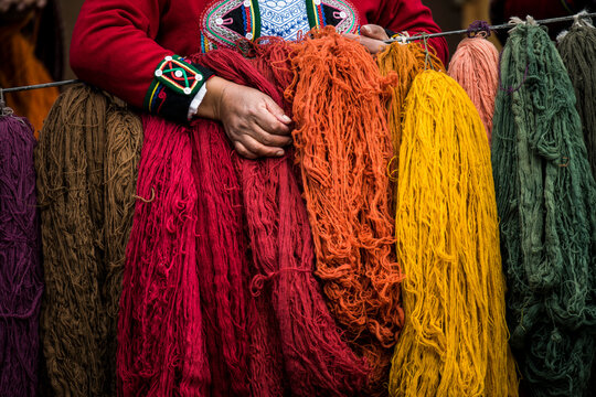 Quechuan women of Chinchero weaving in traditional ways for sale; Cusco, Peru
