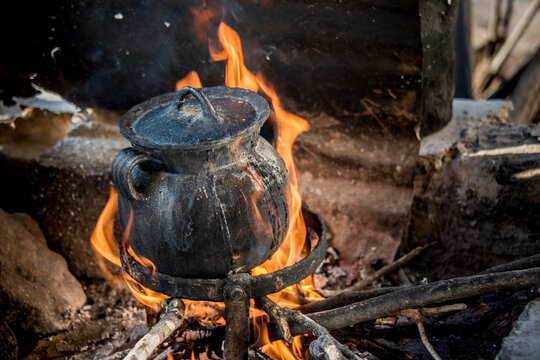 Cooking food in pot over an open flame; Ejido Hidalgo, San Luis, Mexico