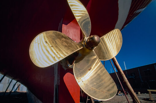 Brass propeller attached to a boat in dry dock; Bodrum, Turkey