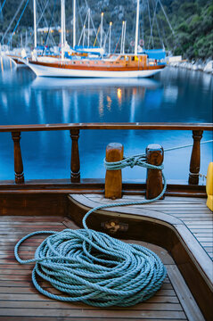 Sailing yachts at anchor in striking blue waters.