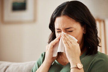 Tissue, blowing nose and woman in a living room with flu, cold and hay fever, crisis or viral...