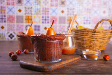 Sweet homemade autumn spicy biscuit mini pie in cup with whole pear