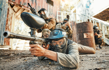 Paintball, team and people in action with gun for tournament, competition and battle in nature....