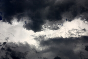 Fototapeta premium Evening summer sky.In a rupture of a dark cloud the light strip of the clouds lit with the sun is visible.