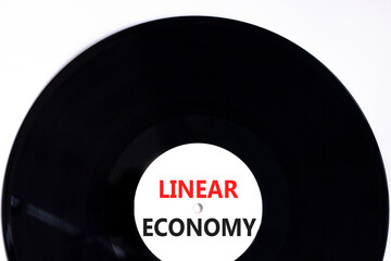 Linear economy symbol. Concept words Linear economy on beautiful black vynil disk. Beautiful white...