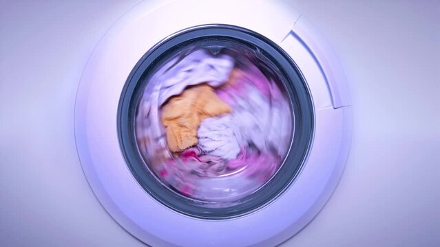 White washing machine washes clothes