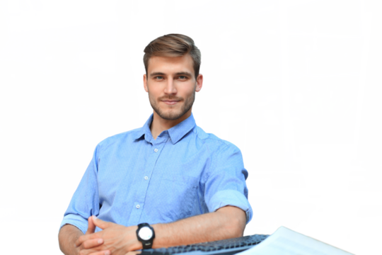 Portrait of happy man sitting at office desk, looking at camera, smiling on a transparent background