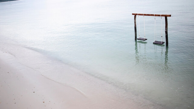 Wooden swings on the beach with views of the calm and beautiful sea water, the beach is perfect for a vacation - belitung Indonesia