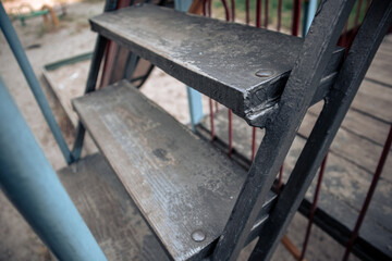 Wooden steps on an old iron staircase