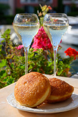 Celebration with champagne sparkling wine and french stuffed with apples or chocolate beignets donuts pastry, sweet dessert served outdoor