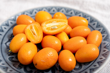 Delicious small citrus fruits orange kumquats close up