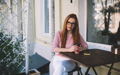 Smiling woman sitting with coffee cup at table