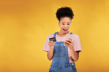 Woman, credit card and wow with phone, studio and shock face for deal, discount or sale by yellow background. Gen z girl, smartphone and banking with surprise for investment, scam and fintech app