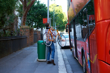 En route to work. Shot of a man with his bicycle at a bus stop. © Nicola Katie/peopleimages.com