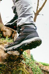 Man wearing outdoor shoes in the nature, climbing and trekking theme
