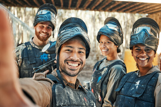 Paintball team, happy selfie and group together, smile and happiness for action game, army mission and memory photo. Battlefield arena, war soldier and military post training picture to social media