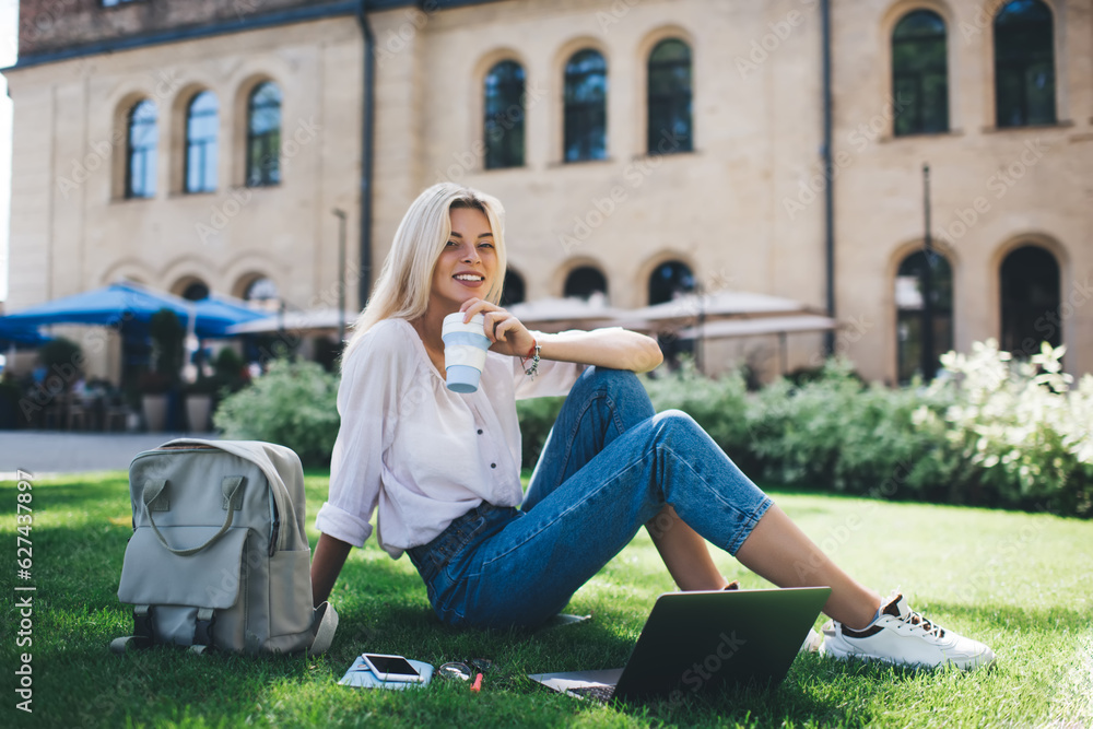 Poster portrait of happy hipster girl with coffee to go and modern laptop computer for freelance programmin