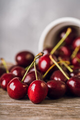 Ripe and juicy cherries on the dark rustic background. Selective focus. Shallow depth of field.
