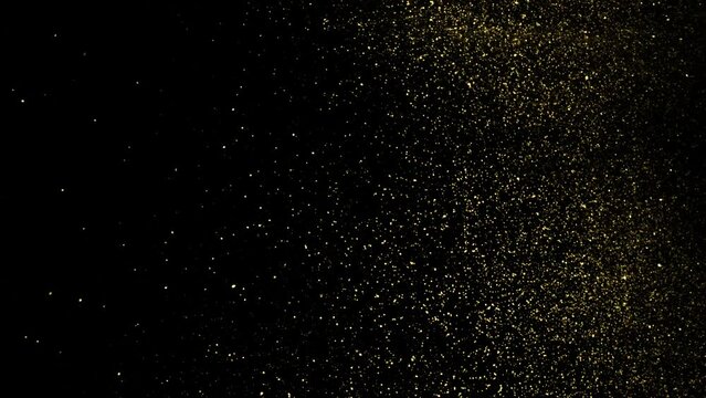 Gold Dust Waves. Particle gold dust flickering on black background. Gold Particles Moving Background. Particle from below. 4k abstract Footage background for text.