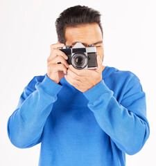 Fototapeta premium Retro camera, photography and man in studio for photoshoot, creative media and paparazzi. Male photographer, journalist and shooting with vintage equipment for production, lens and white background