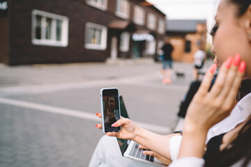 Young woman taking selfie on smartphone