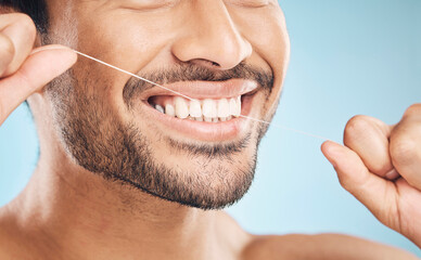 Wellness, teeth closeup and flossing of a man with cleaning and dental health in a studio. Face,...