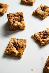 blondie cookies squares on white marble countertop background. White chocolate sweet and tasty, chewy cookie bars. 