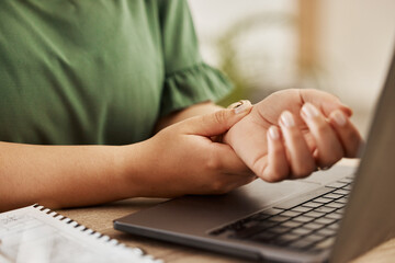Closeup, laptop and woman with wrist pain, injury and overworked by desk, sprain hand or joint....